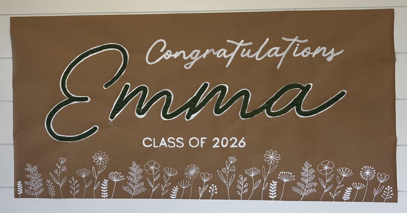 Hand-painted banner: Congratulations Emma, class of 2026