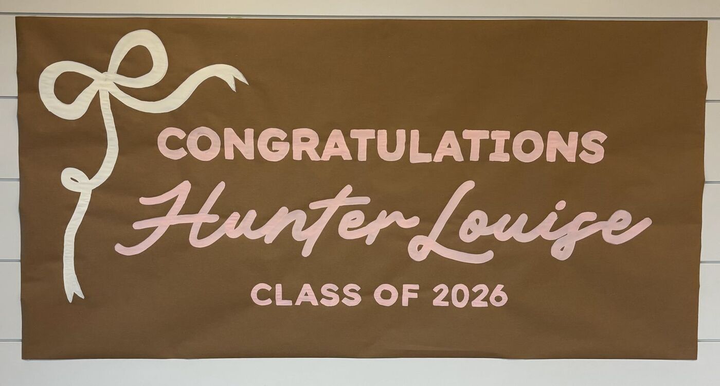 Hand-painted banner: Congratulations Hunter Louise, class of 2026