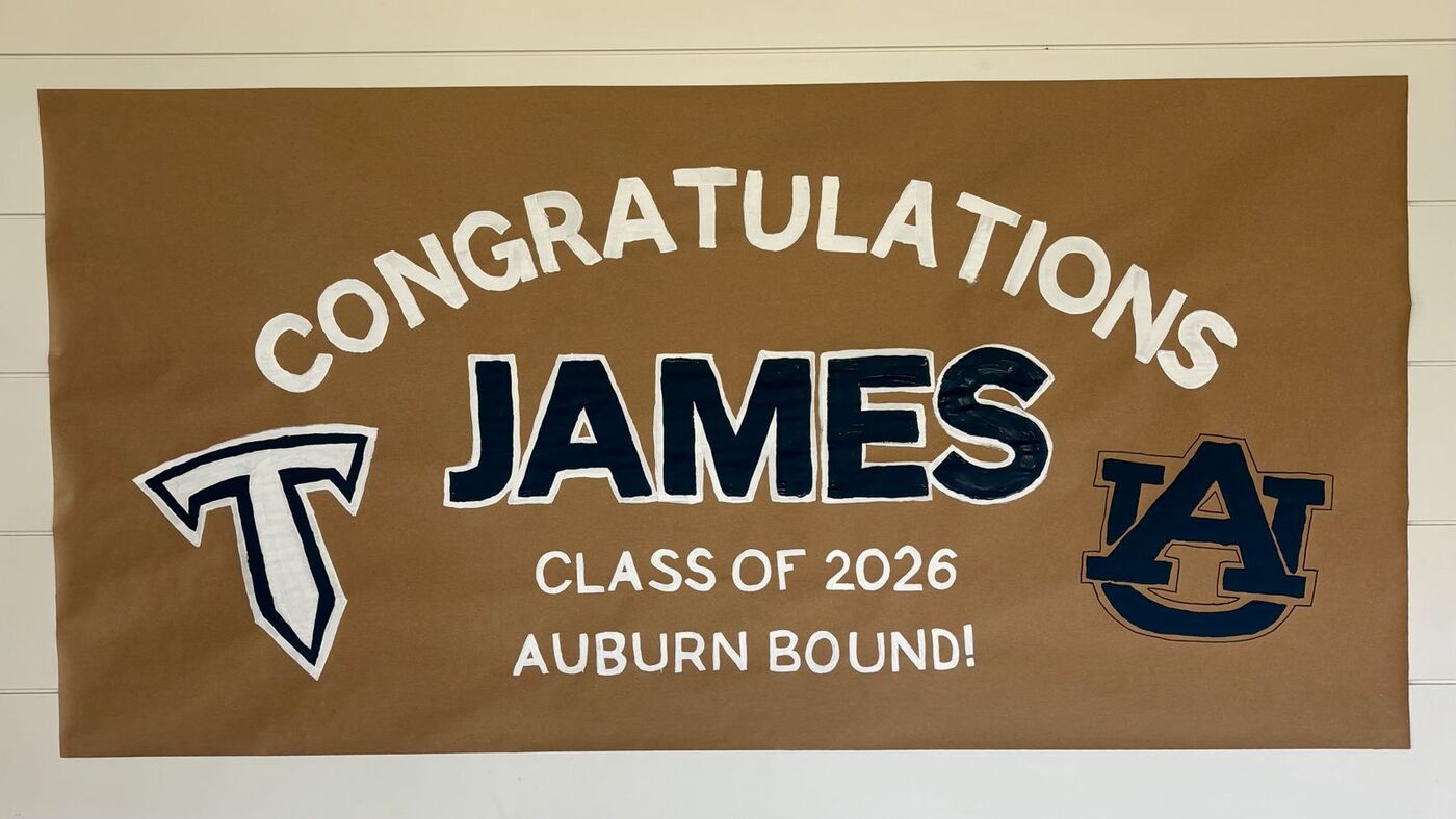 Hand-painted banner: Congratulations James, Auburn bound